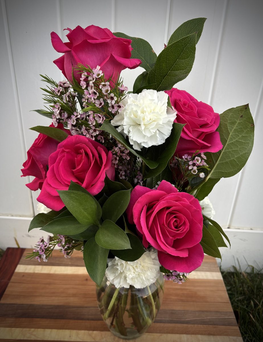 Half Dozen Roses - Six pink roses with white carnations in a vase